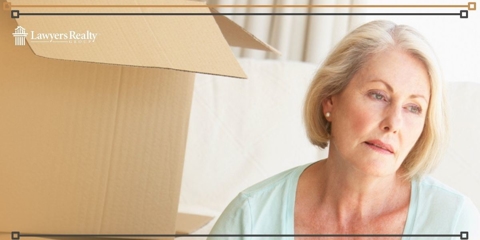 Sad woman packing up items from her home