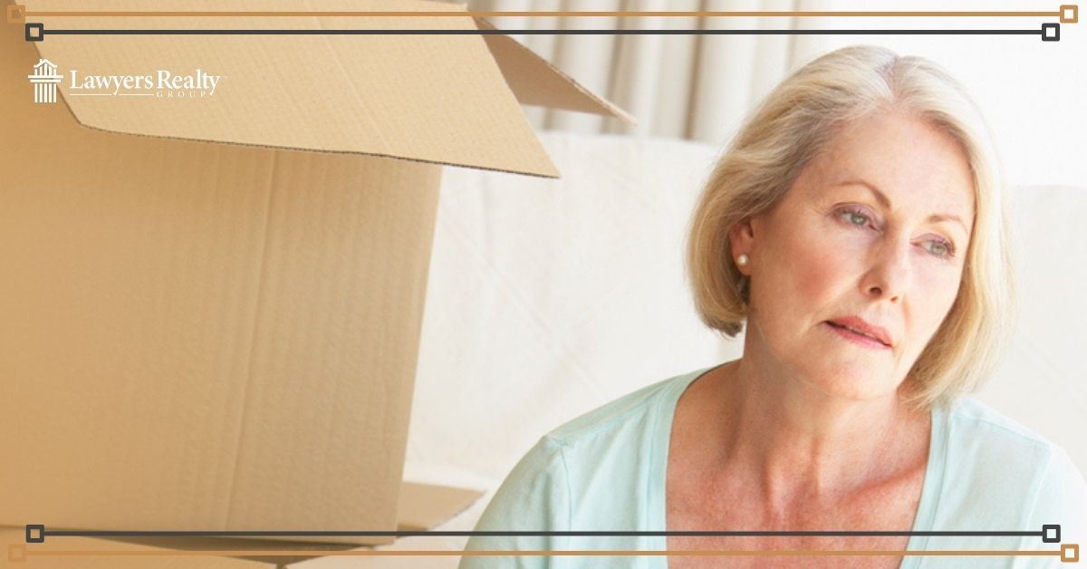 Sad woman packing up items from her home